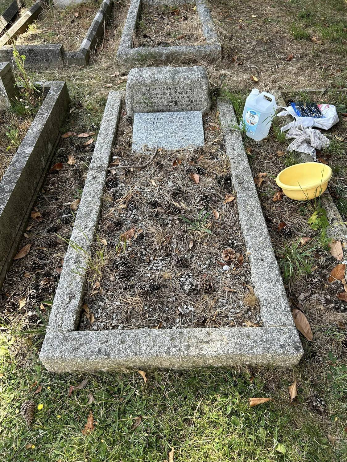 Peter Tranchell's grave during cleaning in June 2023